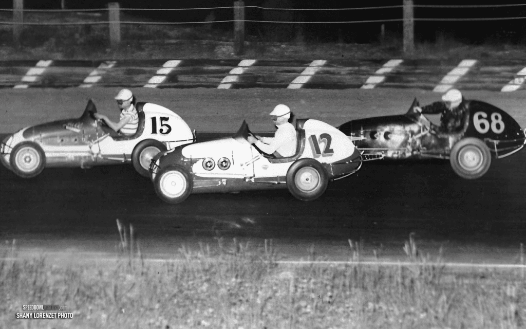 Black and white abstract pattern with concentric circles and wave shapes.