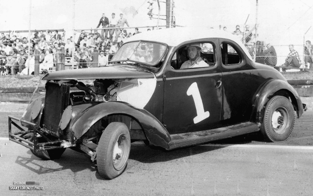 Black and white abstract pattern with concentric circles and wave shapes.