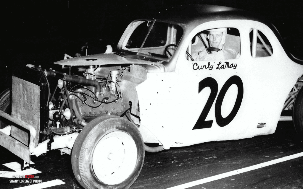 Black and white abstract pattern with concentric circles and wave shapes.