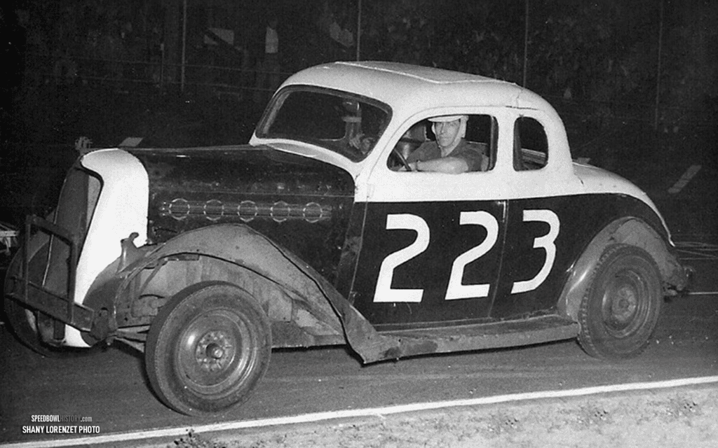 Black and white abstract pattern with concentric circles and wave shapes.