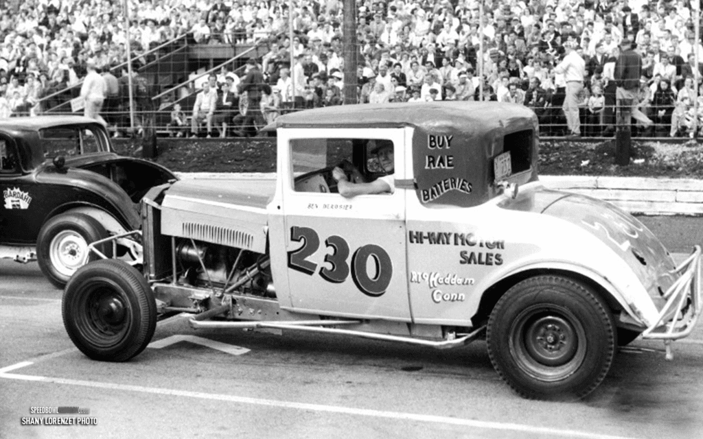 Black and white abstract pattern with concentric circles and wave shapes.