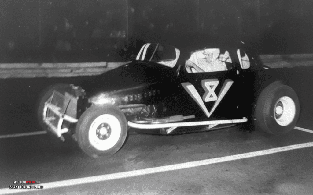 Black and white abstract pattern with concentric circles and wave shapes.