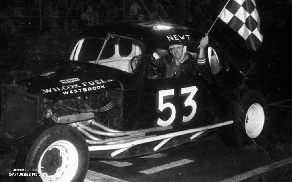 Black and white abstract pattern with concentric circles and wave shapes.