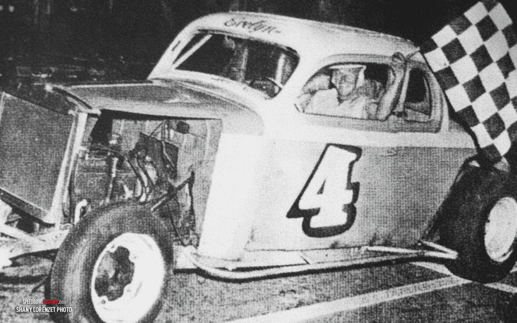 Black and white abstract pattern with concentric circles and wave shapes.