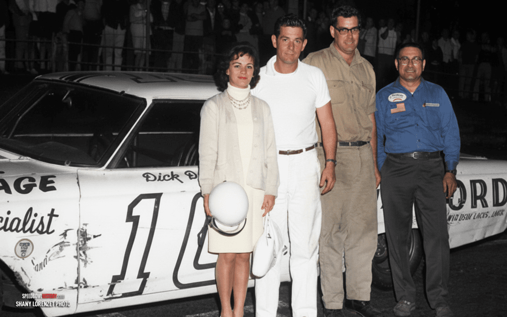 Black and white abstract pattern with concentric circles and wave shapes.