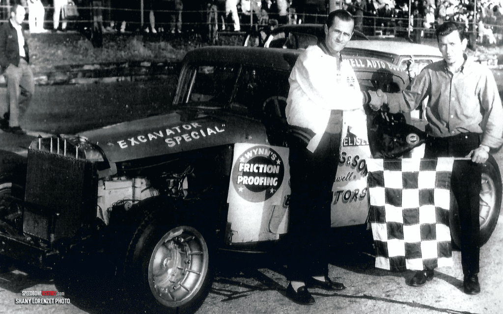 Black and white abstract pattern with concentric circles and wave shapes.