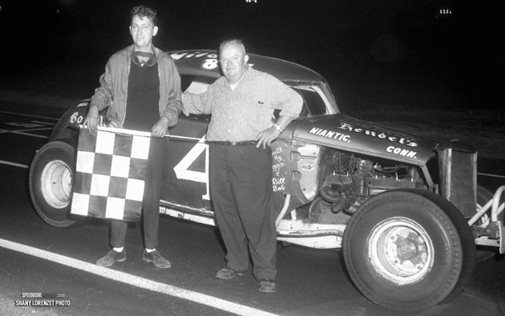 Black and white abstract pattern with concentric circles and wave shapes.