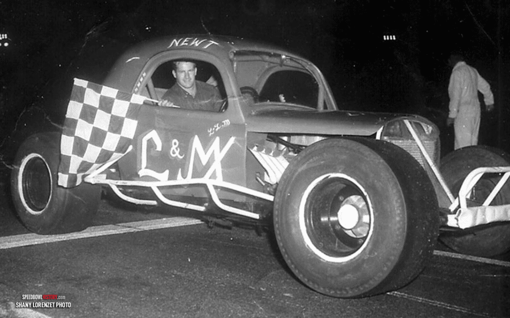 Black and white abstract pattern with concentric circles and wave shapes.