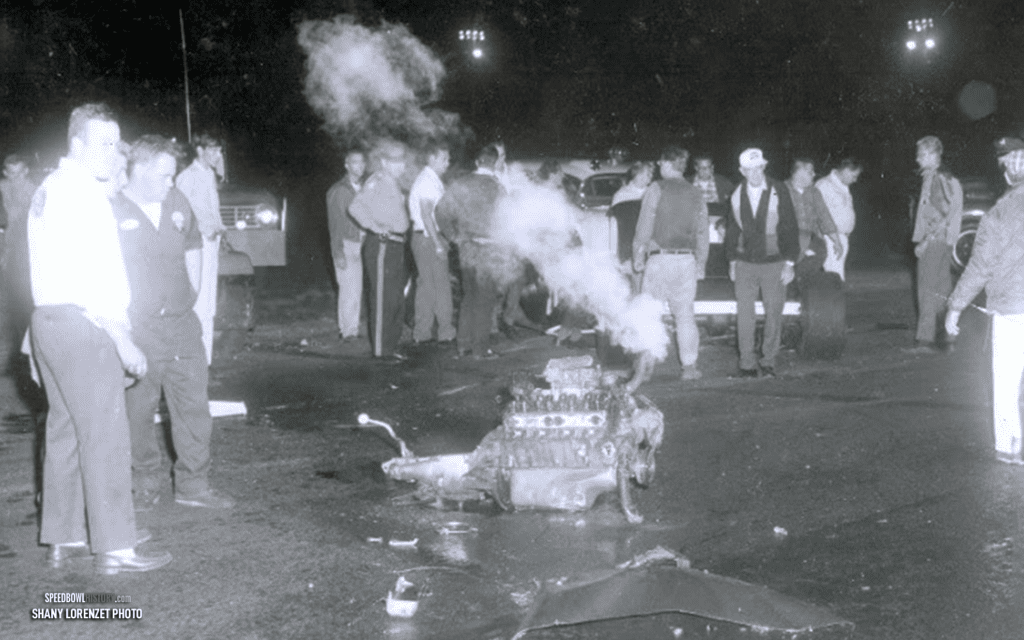 Black and white abstract pattern with concentric circles and wave shapes.