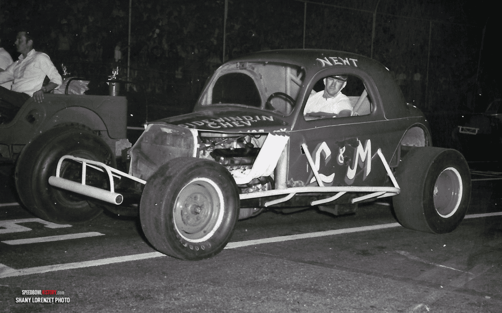 Black and white abstract pattern with concentric circles and wave shapes.