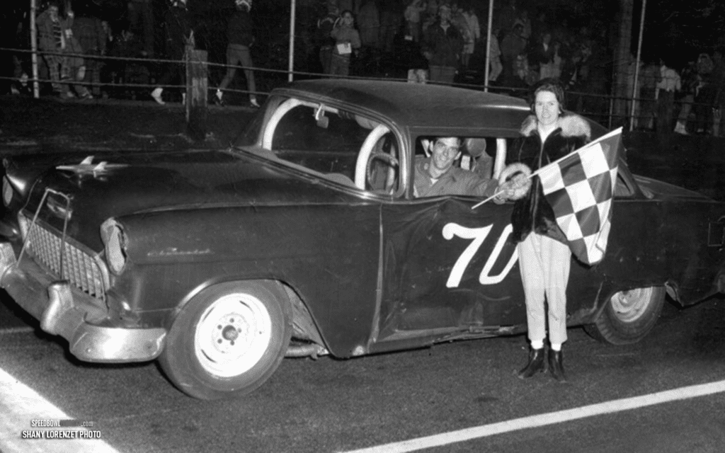 Black and white abstract pattern with concentric circles and wave shapes.