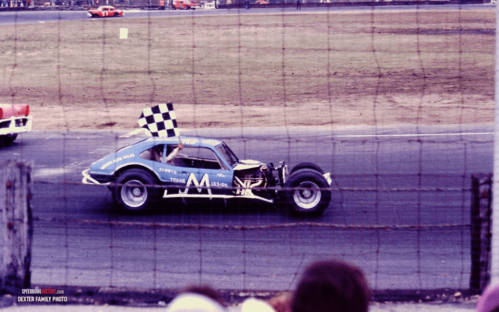 Black and white abstract pattern with concentric circles and wave shapes.