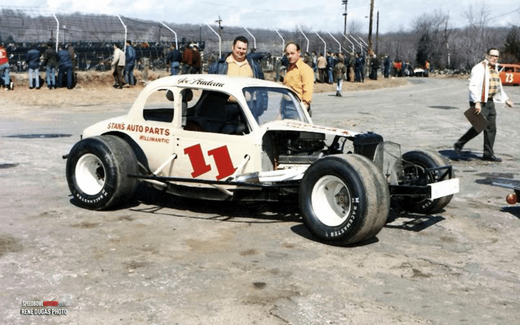 Black and white abstract pattern with concentric circles and wave shapes.