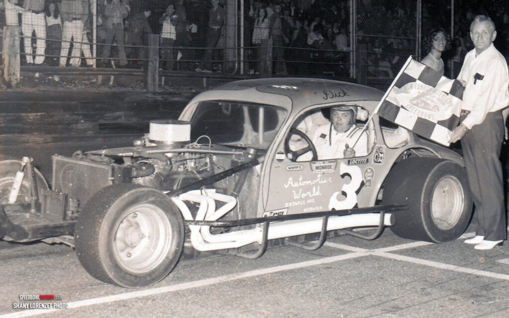 Black and white abstract pattern with concentric circles and wave shapes.