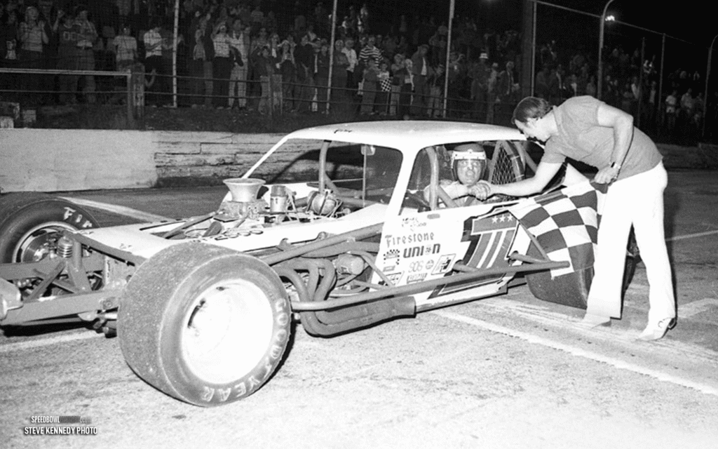 Black and white abstract pattern with concentric circles and wave shapes.