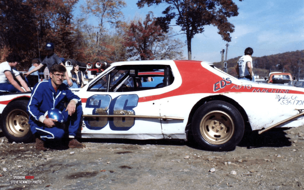 Black and white abstract pattern with concentric circles and wave shapes.