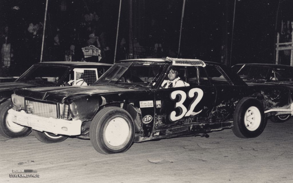 Black and white abstract pattern with concentric circles and wave shapes.