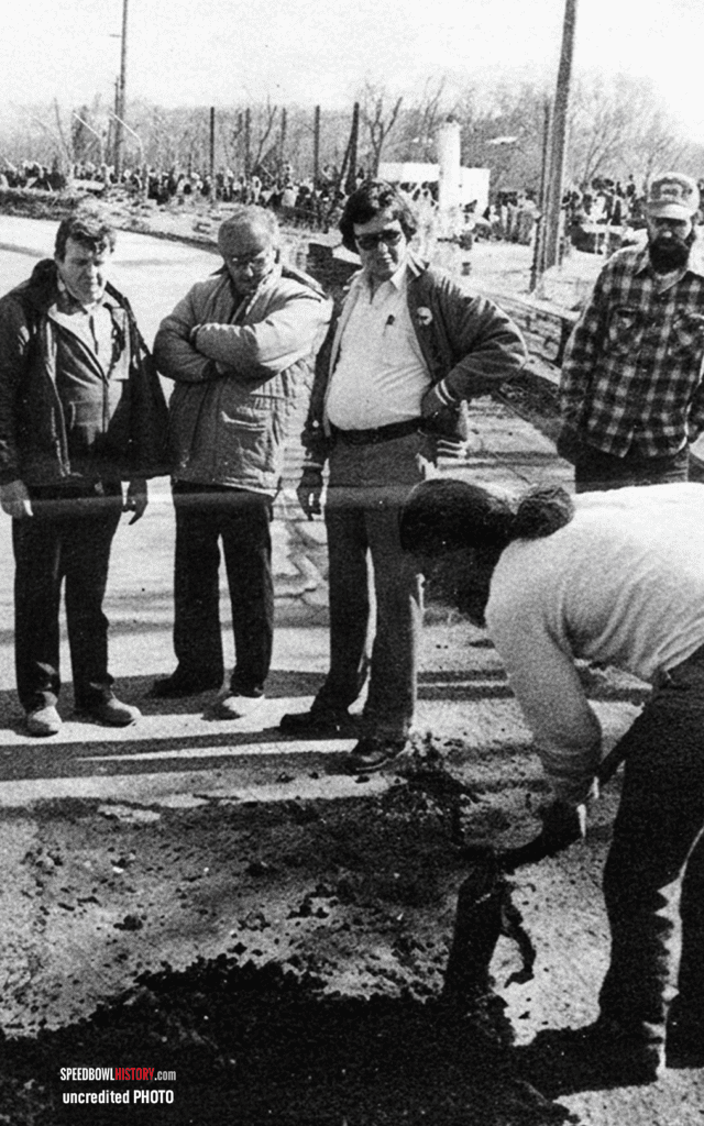 Black and white abstract pattern with concentric circles and wave shapes.