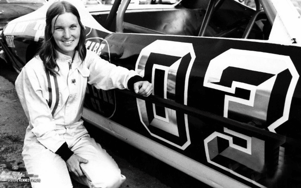 Black and white abstract pattern with concentric circles and wave shapes.