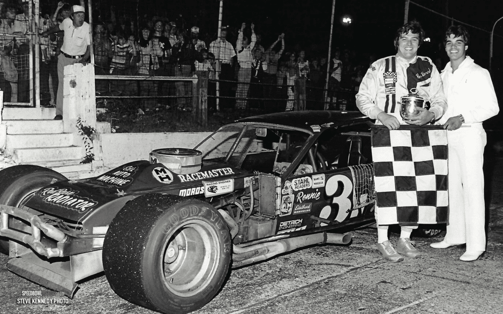 Black and white abstract pattern with concentric circles and wave shapes.