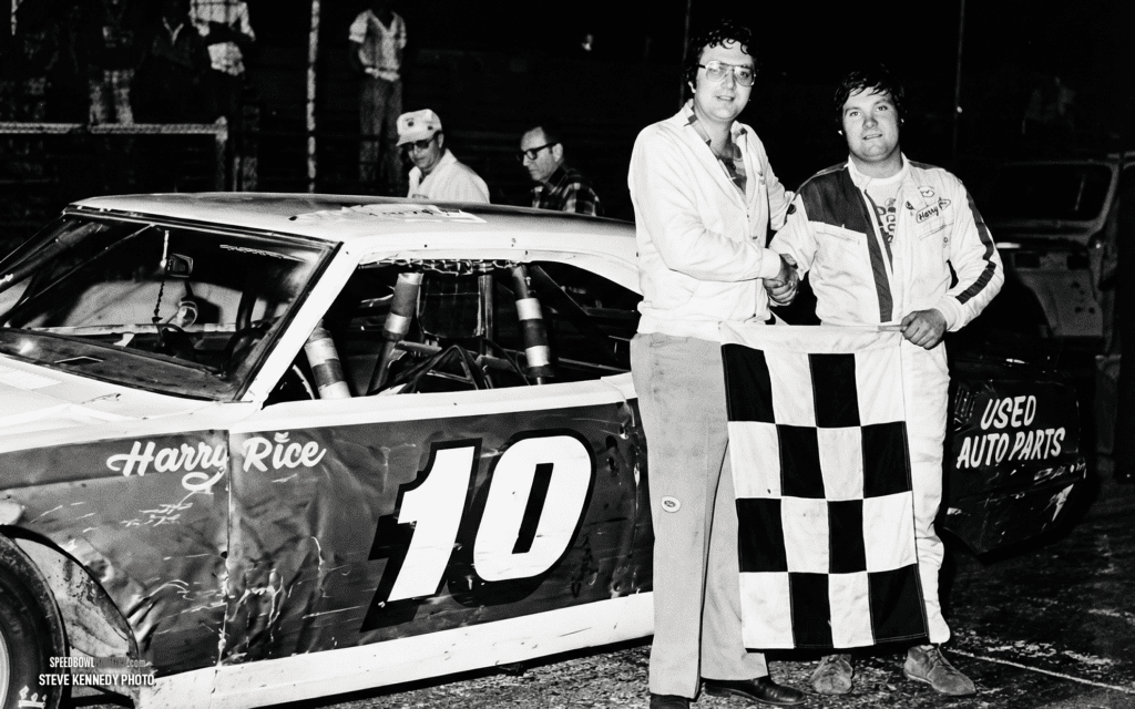 Black and white abstract pattern with concentric circles and wave shapes.