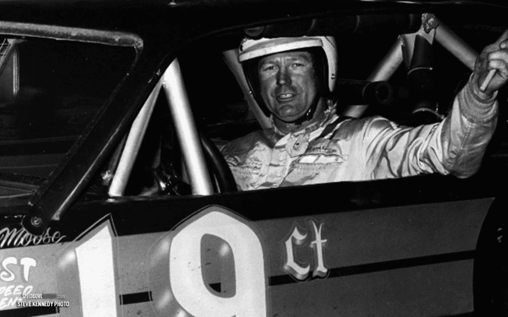 Black and white abstract pattern with concentric circles and wave shapes.