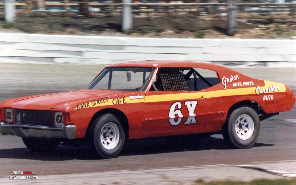 Black and white abstract pattern with concentric circles and wave shapes.