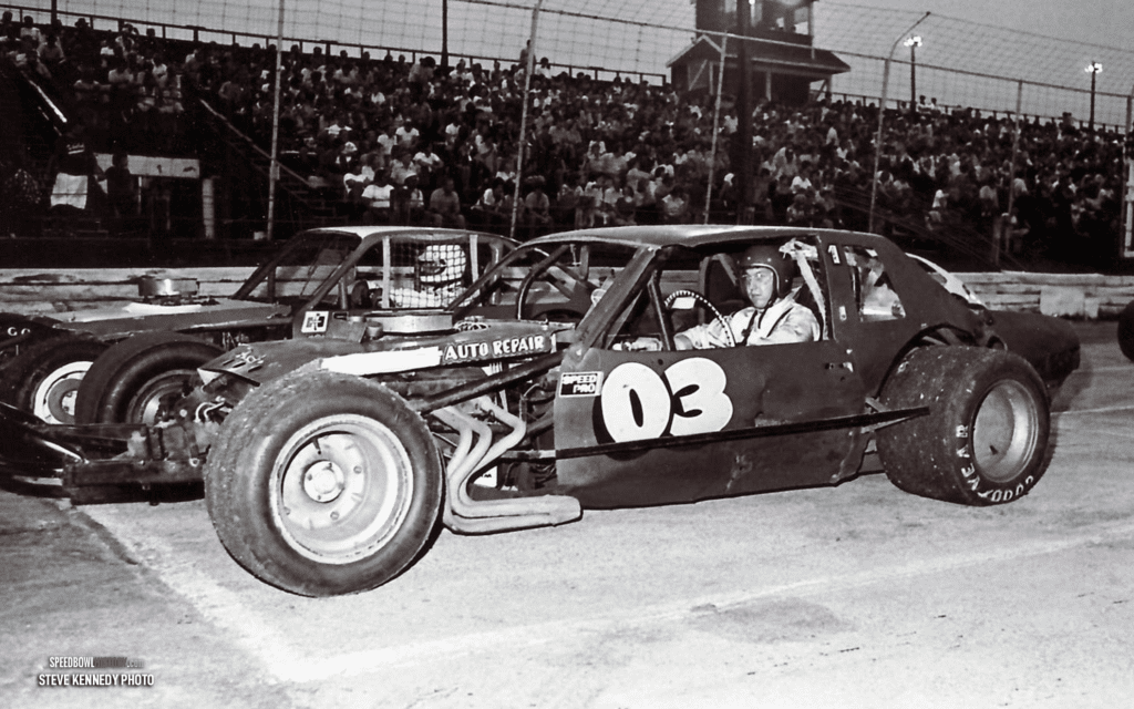 Black and white abstract pattern with concentric circles and wave shapes.