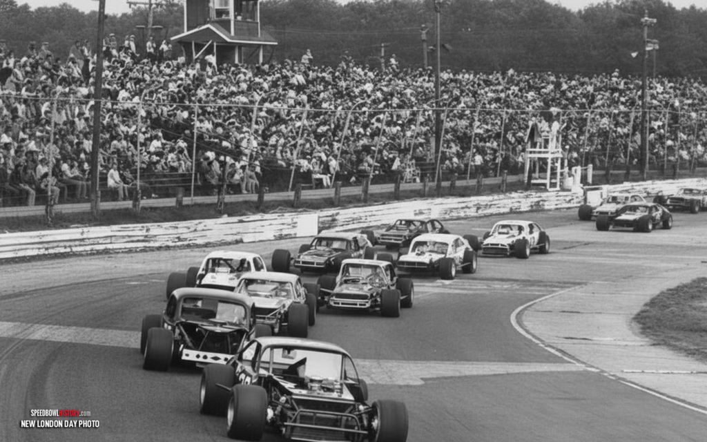 Black and white abstract pattern with concentric circles and wave shapes.