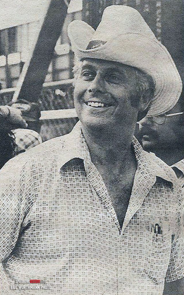 Black and white abstract pattern with concentric circles and wave shapes.