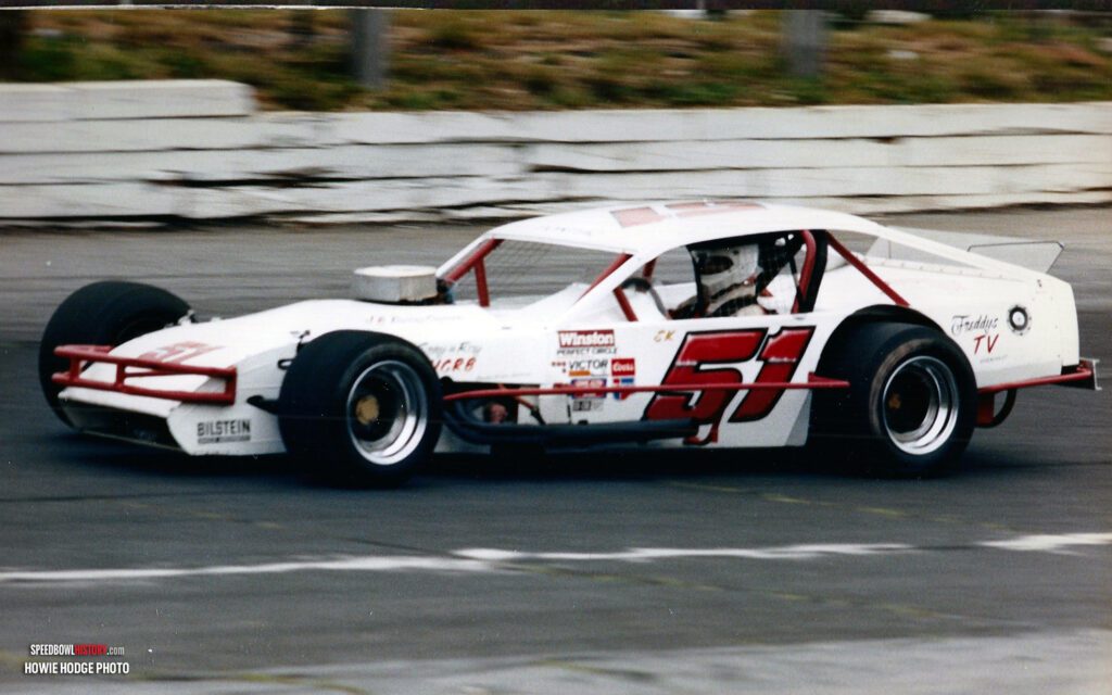 Black and white abstract pattern with concentric circles and wave shapes.