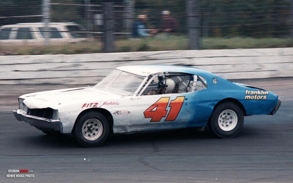 Black and white abstract pattern with concentric circles and wave shapes.