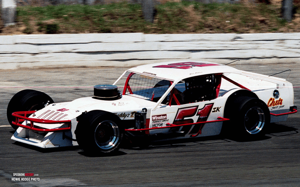 Black and white abstract pattern with concentric circles and wave shapes.