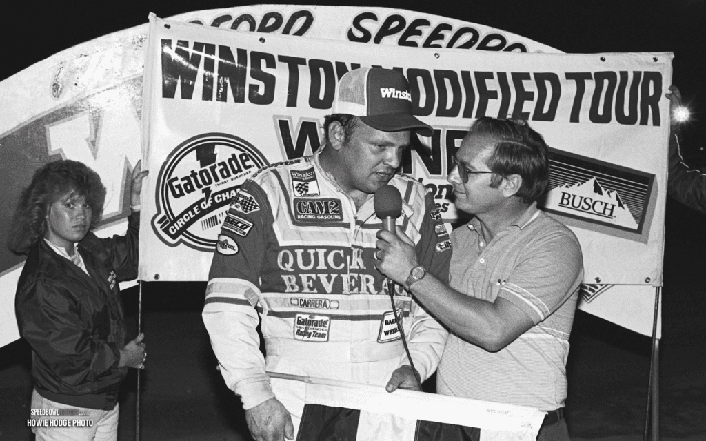 Black and white abstract pattern with concentric circles and wave shapes.