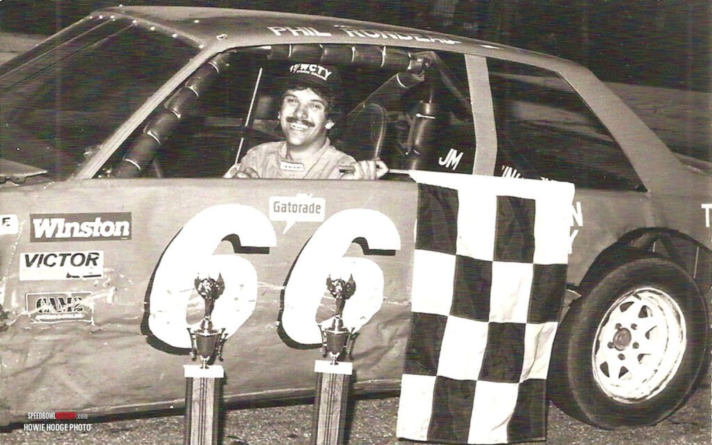 Black and white abstract pattern with concentric circles and wave shapes.