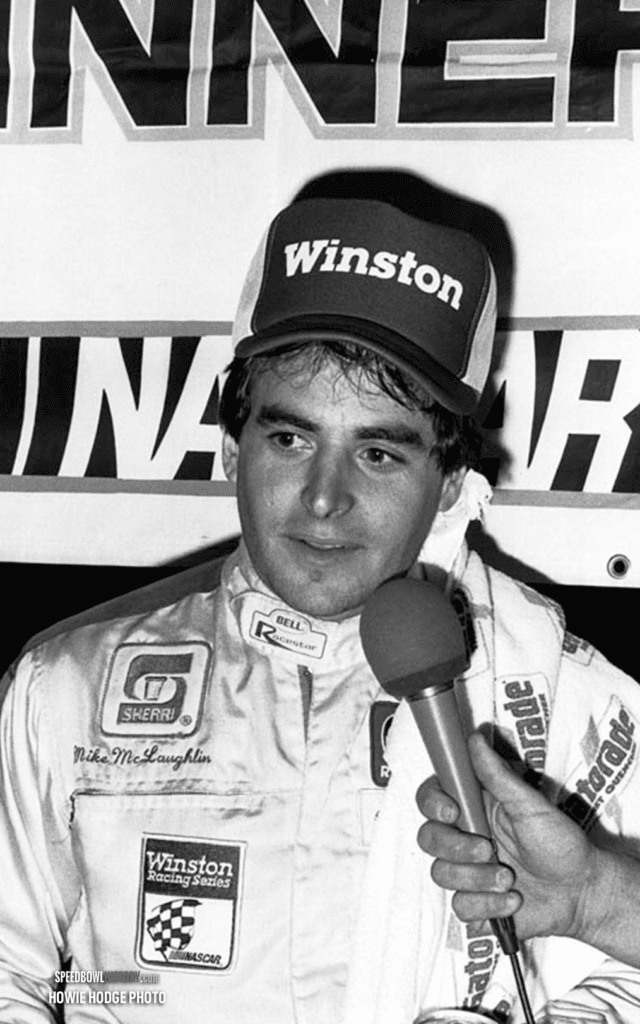 Black and white abstract pattern with concentric circles and wave shapes.