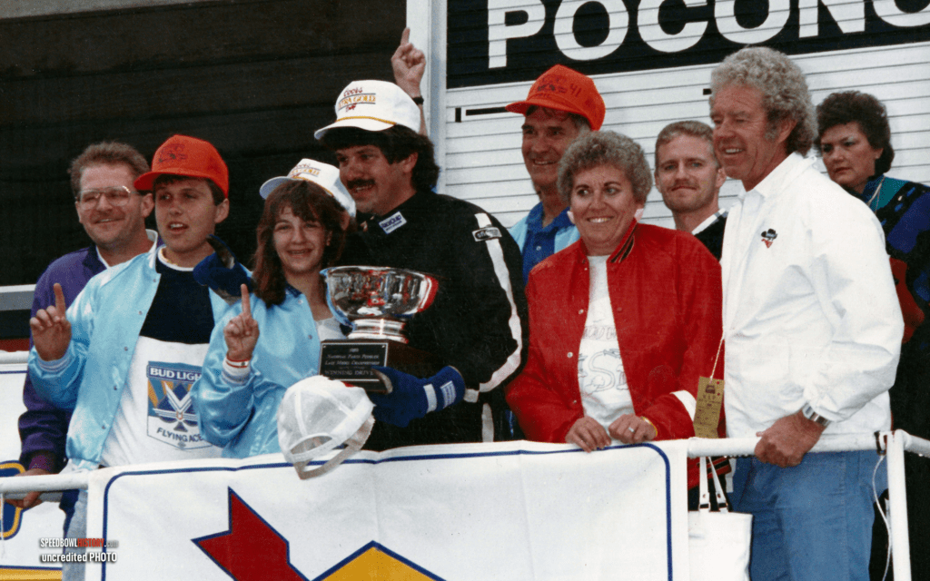 Black and white abstract pattern with concentric circles and wave shapes.