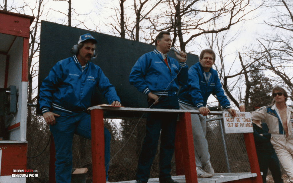 Black and white abstract pattern with concentric circles and wave shapes.