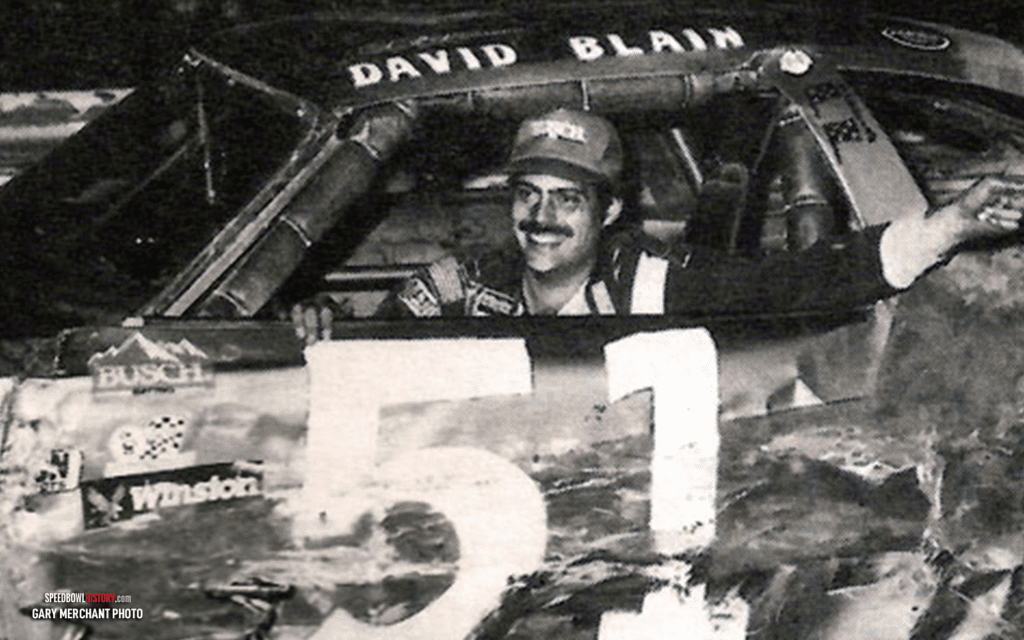 Black and white abstract pattern with concentric circles and wave shapes.