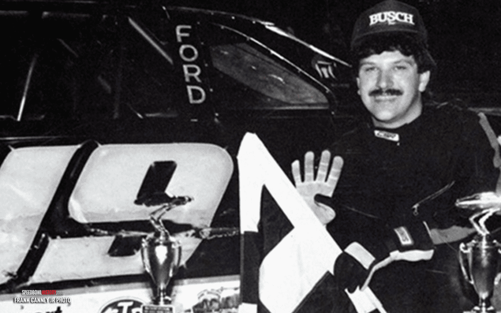 Black and white abstract pattern with concentric circles and wave shapes.