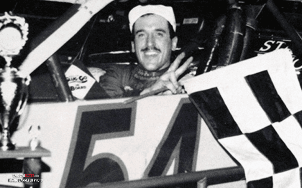 Black and white abstract pattern with concentric circles and wave shapes.