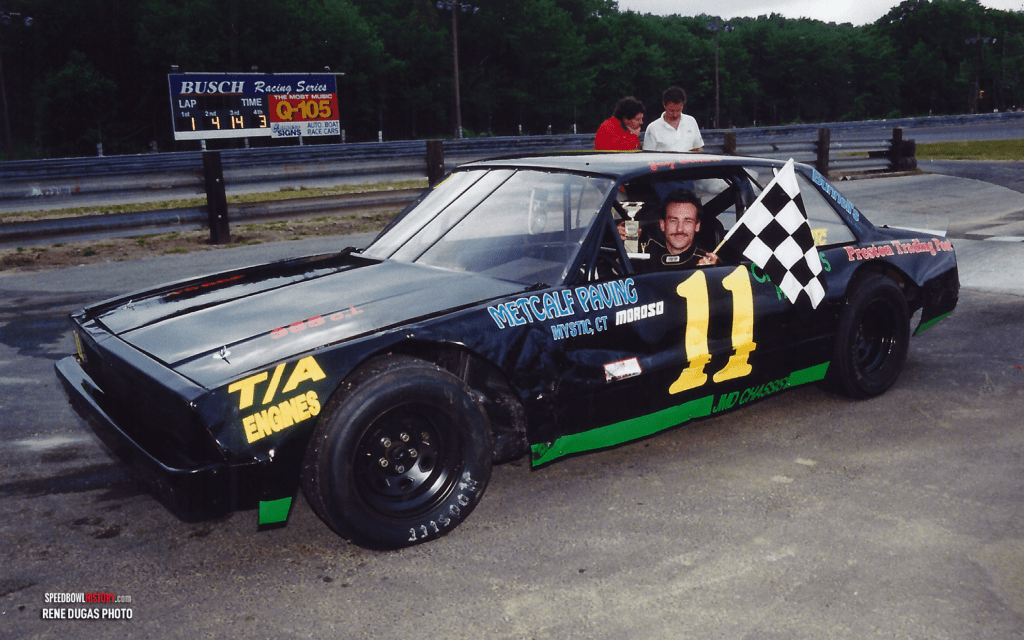Black and white abstract pattern with concentric circles and wave shapes.