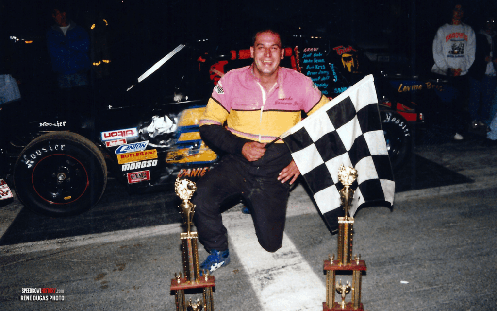 Black and white abstract pattern with concentric circles and wave shapes.