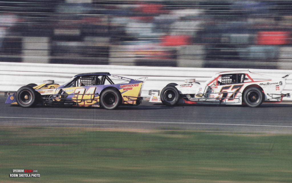 Black and white abstract pattern with concentric circles and wave shapes.