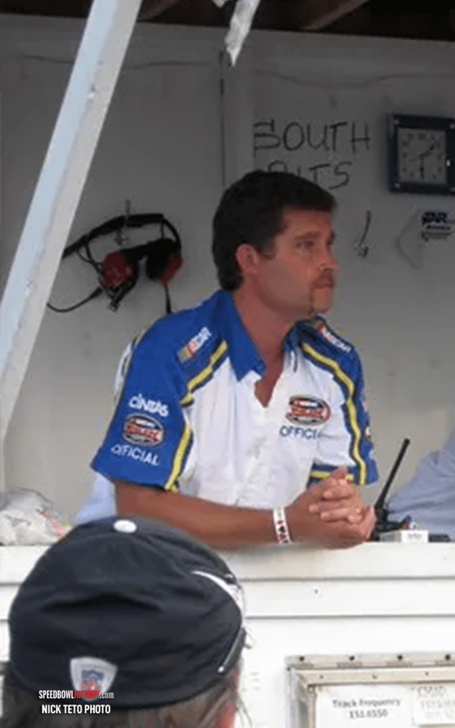 Black and white abstract pattern with concentric circles and wave shapes.