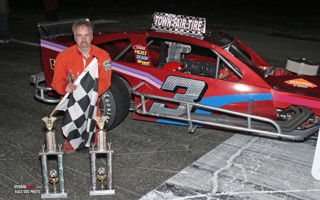 Black and white abstract pattern with concentric circles and wave shapes.