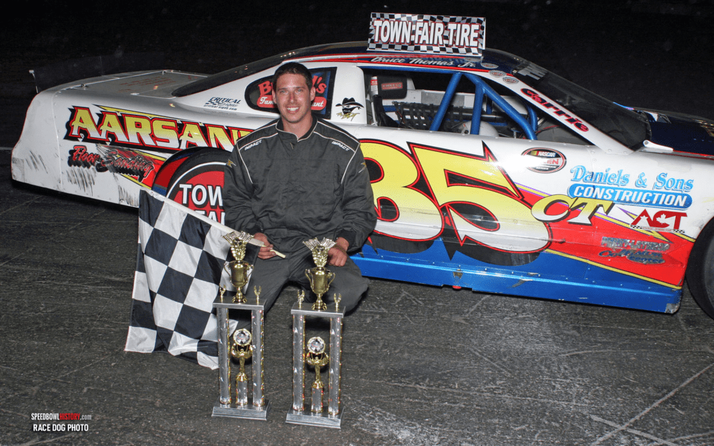 Black and white abstract pattern with concentric circles and wave shapes.