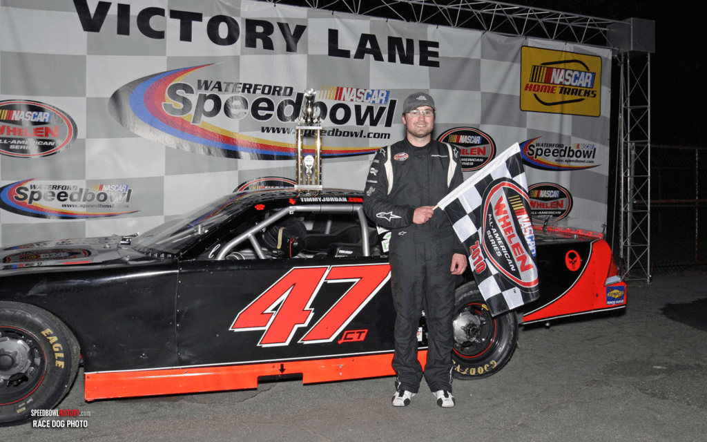 Black and white abstract pattern with concentric circles and wave shapes.