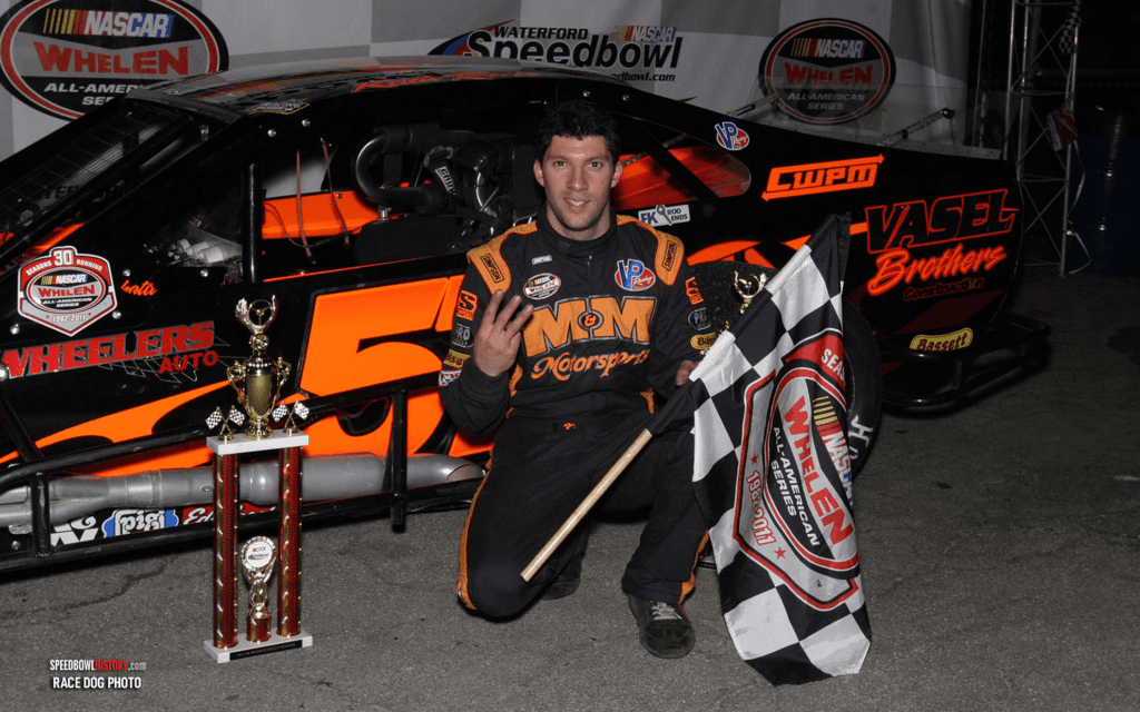 Black and white abstract pattern with concentric circles and wave shapes.