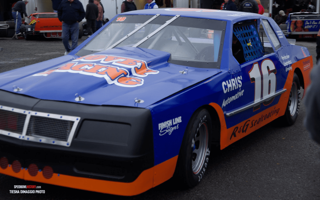 Black and white abstract pattern with concentric circles and wave shapes.